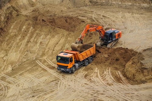 Tracked hydraulic excavator performing deep basement bench excavation